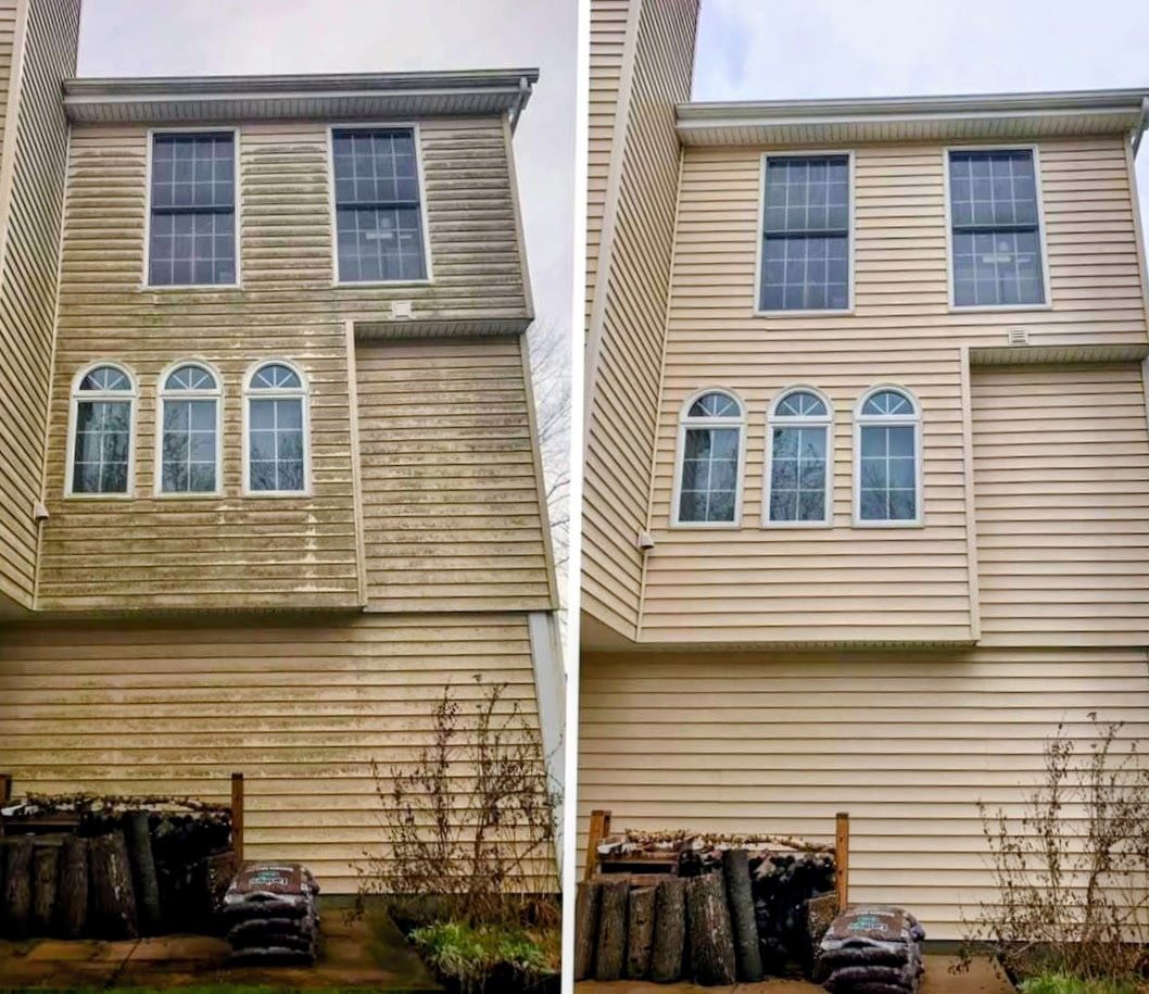 Vinyl siding on a multi-story home before and after soft-wash cleaning